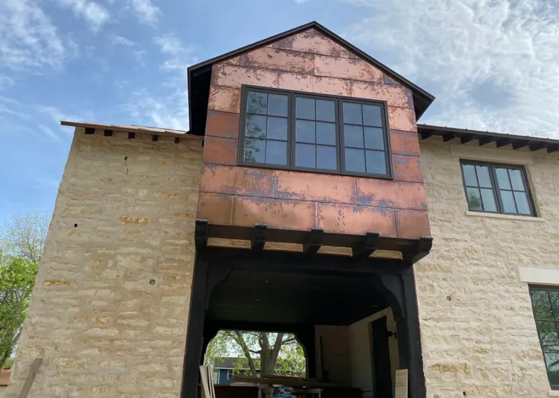 Copper metal panel facade on a stone building for Skylight Installation in Mission Viejo